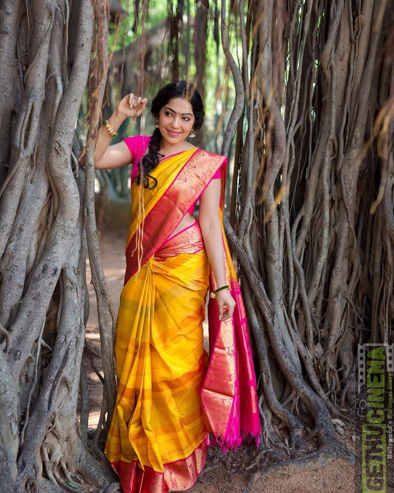 ramya vj in yellow silk saree flowers traditional look pose with pink blouses banyan tree