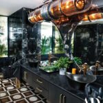 Karan Johar Instagram - For @archdigestindia : “This home is bespoke; it’s one of a kind. It is designed to reflect who Karan is: glamorous, fun, and also a little over the top! It’s not a space that can be imitated,” says interior designer Gauri Khan (@gaurikhan). Knowing Karan’s largesse and his love for entertaining, Gauri wanted the home to serve as a seamless extension of his personality, where guests could make themselves comfortable from the get-go. The main entryway wall is clad in a dramatic, fluted, black-and-white “panda” marble that lines the passageway into a light-filled living room, the tall, arched French windows open onto a serene terrace—Karan's favourite spot—dotted with tropical plants, where he can enjoy his coffee. Both Karan and Gauri also admit to an affinity for the powder room—during the day, the sunlight filters in, reflecting off the glossy surfaces—which Khan accented with a statement turbine light, a vanity with marble horse-head detail, and a forest-green wall. While Gauri has used a medley of richer tones for the public areas, for Karan’s private spaces—his dressing room, bedroom, and bathroom—she adopted a softer palette of beiges, muted metal tones, and wooden herringbone floors, while still keeping some distinctive threads to tie in the entire design story. Explore the filmmaker's home at the link in bio. On Stands NOW! Photography by: Ishaan Nair (@ishaannair7) Words by: Priyanka Khanna (@priyankaskhanna) Art Director: Chandni Mehta (@thebombaycat) Production: Harshita Nayyar (@harshitanayyar_) Karan Johar's team: Manager: Lenn Soubam (@len5bm) Fashion Stylist: Eka Lakhani (@ekalakhani) Assistant Stylist: Arpita Chonkar (@arpita.kc) & Mayuri Srivastava (@mayuri_srivastava) Hair: Aalim Hakim (@aalimhakim) Makeup: Paresh Kalgutkar (@paresh_kalgutkar) Gauri Khan's team: Managed by : Bottomline Media pvt ltd (@bottomlinemedia) Hair: Rishika Chaudhry Makeup: Saba Khan (@sabakhanmakeup)
