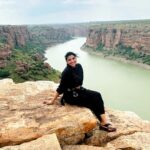 Lahari Shari Instagram - Perched on this mighty rock, my heart races with adrenaline still coursing through my veins. The thrill of rope sliding at Gandikota was like dancing with danger itself. And now, as I sit here, the breathtaking view before me takes my breath away once again. Life is but a daring adventure, and I'm here to embrace every exhilarating moment. 🌄✨ #LivingOnTheEdge #GandikotaGush #Gandikota #ThrillSeeker #AdventureAwaits Gandikotahilltopcamping