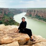 Lahari Shari Instagram - Perched on this mighty rock, my heart races with adrenaline still coursing through my veins. The thrill of rope sliding at Gandikota was like dancing with danger itself. And now, as I sit here, the breathtaking view before me takes my breath away once again. Life is but a daring adventure, and I'm here to embrace every exhilarating moment. 🌄✨ #LivingOnTheEdge #GandikotaGush #Gandikota #ThrillSeeker #AdventureAwaits Gandikotahilltopcamping