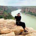 Lahari Shari Instagram - Perched on this mighty rock, my heart races with adrenaline still coursing through my veins. The thrill of rope sliding at Gandikota was like dancing with danger itself. And now, as I sit here, the breathtaking view before me takes my breath away once again. Life is but a daring adventure, and I'm here to embrace every exhilarating moment. 🌄✨ #LivingOnTheEdge #GandikotaGush #Gandikota #ThrillSeeker #AdventureAwaits Gandikotahilltopcamping