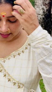Anumol Instagram - Days like these.. 
I was down with fever and cold on this day and had to attend an inauguration with swollen face, running nose and heavy head. On d way back we just dropped in at Vazhalikaavu and captioned this . 

Wearing @tantra_by_sanajijith 
Captured by @nattupaathakal 

#offwhiteandgold #dressoftheday #anumol #anuyathra #tantrabysanajijith #designerwear #spreadkindness #lovelovelove #peace✌️