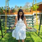 Poornima Ravi Instagram - Stretch back and swing to fly higher 😊❤️ . . . . . . . . . . . . . #poornimaravi #araathi #whitegown #white #whiteoutfit #whitedresses #love #ooty #swing #smile #loveyourself #lovestory #happy #fashionphotography hionphotography #candid #candidphotography