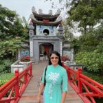 Archita Sahu Instagram - Many of you asked what I was wearing in last few posts . That’s ‘Ao dai’ . It’s the Vietnamese dress basically a silk tunic with straight pants . I got to know about it while talking to few locals who helped me with the shop address too to buy from. And here I am with few newly made local friends ❤️ NB : last pic shows my touristy mode 😂 #aodai #hoankiem #cafe #SabyArchita #archita #travel #road #rickshaw #bus #cafehoankiem #highlandcoffee