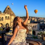 Kritika Sharma Instagram - The most favourite part of my turkey trip to do this 🤍 #gratitude Outfit @sainygargcouture Styled by @_vaishnavii.3011 Location @sultan_cave_suites #travel #whitedress #cappadocia #hotairballoon #photoshoot #terrace Sultan Cave Suites