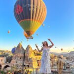 Kritika Sharma Instagram - The most favourite part of my turkey trip to do this 🤍 #gratitude Outfit @sainygargcouture Styled by @_vaishnavii.3011 Location @sultan_cave_suites #travel #whitedress #cappadocia #hotairballoon #photoshoot #terrace Sultan Cave Suites