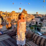 Kritika Sharma Instagram - The most favourite part of my turkey trip to do this 🤍 #gratitude Outfit @sainygargcouture Styled by @_vaishnavii.3011 Location @sultan_cave_suites #travel #whitedress #cappadocia #hotairballoon #photoshoot #terrace Sultan Cave Suites