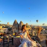 Kritika Sharma Instagram - The most favourite part of my turkey trip to do this 🤍 #gratitude Outfit @sainygargcouture Styled by @_vaishnavii.3011 Location @sultan_cave_suites #travel #whitedress #cappadocia #hotairballoon #photoshoot #terrace Sultan Cave Suites