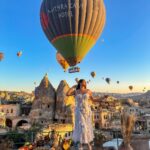 Kritika Sharma Instagram - The most favourite part of my turkey trip to do this 🤍 #gratitude Outfit @sainygargcouture Styled by @_vaishnavii.3011 Location @sultan_cave_suites #travel #whitedress #cappadocia #hotairballoon #photoshoot #terrace Sultan Cave Suites