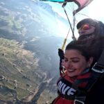 Madhu Sharma Instagram - Skydiving is an exhilarating and unforgettable experience that is difficult to put into words. As you ascend to your jump altitude, your heart races with anticipation and nerves. Once you reach the jump altitude, you take a deep breath and leap out of the plane. In the first few seconds, you will feel a rush of wind as you plummet towards the earth. The sensation of free-fall is indescribable; you feel weightless and the wind rushing past you at an incredible speed. You may also experience a feeling of absolute freedom and a sense of being completely alive. After around 45-60 seconds of free-fall, your parachute is deployed, and you suddenly slow down, allowing you to take in the stunning views around you. The feeling of being suspended in the air, thousands of feet above the ground, is breathtaking. As you float back to earth, you may feel a sense of tranquility and peacefulness. The experience of skydiving can be described as a rush of adrenaline mixed with a deep sense of calm and appreciation for the beauty of the world around you. Overall, skydiving is an extraordinary experience that combines intense excitement, breathtaking views, and a sense of freedom and peace. It is truly an experience like no other.