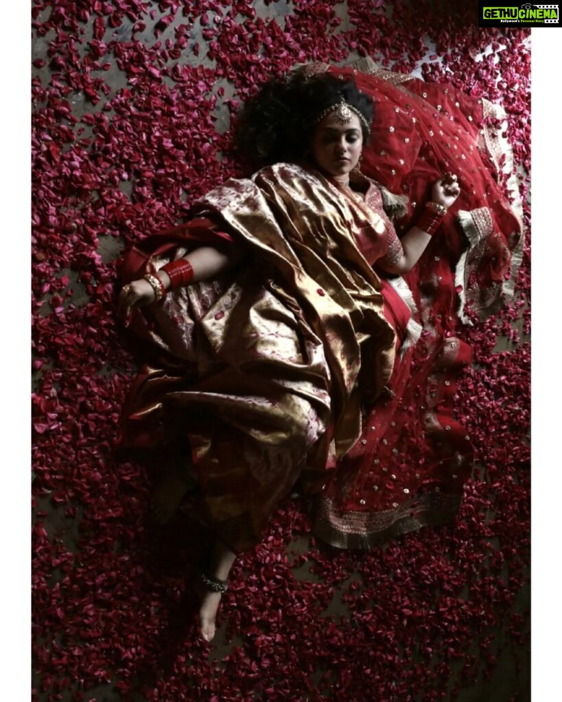 Nithya Menen Instagram - On this auspicious occasion of Navaratri - This is inspired from vintage paintings from India depicting women in red sarees . The Divine Feminine - Goddess Durga is considered to be the physical form of ‘Shakti’ or ‘Universal Energy’. She was created by the Hindu Gods to annihilate the notorious demon ‘Mahisasura’. Reimagine is an attempt at creating a fresh look and feel about a character and spinning a new story out of them. But all are re-interpretations with an intriguing approach, while retaining the visual essence of the original works. Creative direction and styling, make up done by @rishabhad Photography done by @sauvicksengupta Clothes @jayshree_studios Jewelry @tahir_somethingsopure