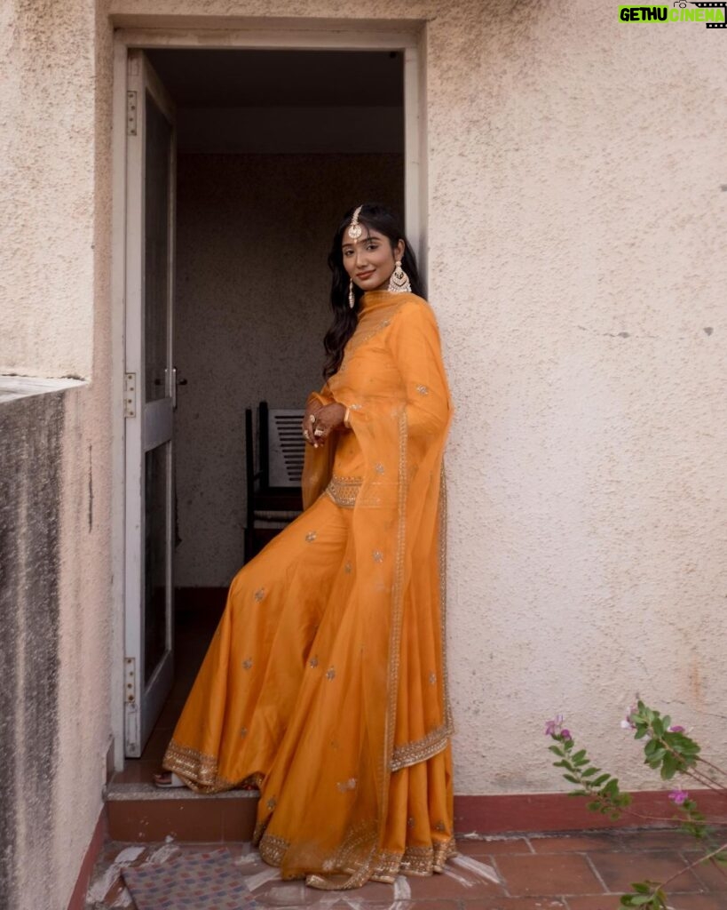 Deepika Venkatachalam Instagram - #Weddinglookbook Mehendi ✨ !! (1/3) “An outfit that gleamed sunset🧡” The theme that we picked up for our mehandi was "Punjabi" & decided to go for outfits that resonated their culture and vibe. It was our stylist @stylingbysamiha who come forward to us and told us to choose from the native colours of Punjab like orange, green or purple to maintain the mood board and my mind immediately went to all those yesteryear Hindi movies where they graced around with patiaalas and short kurtas. @jigarmaliofficial had this gorgeous orange sharara set with an organza dupatta, gold dori & aari embroidery and it was love at first sight for me. I was already thinking of other occasions to wear this over and again! 🥹 Since the dress by itself spoke gorgeousness, samiha suggested minimal jewels that would resonate a Punjabi bride. She herself handpicked the dazzling Tikka and big jumkha from the brand @fineshinejewels and we loved how it complimented the outfit and it gave a neat finish as a whole. Neatly crafted outfit, droolworthy jewels, of course the stunning makeup from @vishualizemua , a cute max hairdo from @saisubha_hairstylist & my tiny shy from the bride to be face of mine gave the evening a whole different glow and I definitely felt right out of the book of an Indian Princess!!🥺 The evening set it's tone 🌥️with family and friends walking to our own terrace to have some fun talk, apply mehendi on their hands and some beautiful music to the ears! . . . . More to come!!! Wait for it!! . 📸 @sakshi.ramakrishnan #RnD #RnDwedding