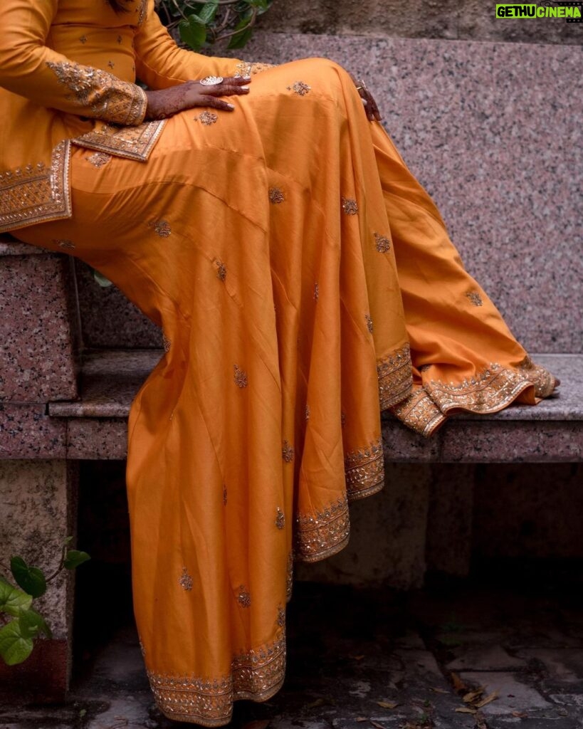 Deepika Venkatachalam Instagram - #Weddinglookbook Mehendi ✨ !! (1/3) “An outfit that gleamed sunset🧡” The theme that we picked up for our mehandi was "Punjabi" & decided to go for outfits that resonated their culture and vibe. It was our stylist @stylingbysamiha who come forward to us and told us to choose from the native colours of Punjab like orange, green or purple to maintain the mood board and my mind immediately went to all those yesteryear Hindi movies where they graced around with patiaalas and short kurtas. @jigarmaliofficial had this gorgeous orange sharara set with an organza dupatta, gold dori & aari embroidery and it was love at first sight for me. I was already thinking of other occasions to wear this over and again! 🥹 Since the dress by itself spoke gorgeousness, samiha suggested minimal jewels that would resonate a Punjabi bride. She herself handpicked the dazzling Tikka and big jumkha from the brand @fineshinejewels and we loved how it complimented the outfit and it gave a neat finish as a whole. Neatly crafted outfit, droolworthy jewels, of course the stunning makeup from @vishualizemua , a cute max hairdo from @saisubha_hairstylist & my tiny shy from the bride to be face of mine gave the evening a whole different glow and I definitely felt right out of the book of an Indian Princess!!🥺 The evening set it's tone 🌥️with family and friends walking to our own terrace to have some fun talk, apply mehendi on their hands and some beautiful music to the ears! . . . . More to come!!! Wait for it!! . 📸 @sakshi.ramakrishnan #RnD #RnDwedding