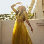 Deepika Venkatachalam Instagram - An outfit like sunshine 💛 ft @athiradesigns On somedays you just wear an outfit and all you want to do is to twirl twirl and twirl!! 🥹 One such outfit is this semi banaras crop top and skirt set from (@athiradesigns) A super cute crop top with attached sheer net and a flowy skirt with lots of flare. I still can’t decide what’s my favorite part about the dress, coz I just love everything about this dress and how it fits perfectly. And the colour!! Aahh!! Gives you a royal look instantly and make heads turn in the crowd. I don’t own many outfits in this colour, so the moment I saw the dress, I knew I want it in my wardrobe. It’s a great option to wear it for haldi, mehandi, sangeeth, birthday parties, family functions, oh come on, for what not!! You can be ready in a minute and slay anywhere!❤️ To elevate the trendiness of the look, we decided to go for a kutty jumkha and bangles. And when I looked at the mirror, I felt like a princess🙈 So I decided to go to the terrace during the golden hour to twirl my heart out and take some beautiful pictures with our team. I love how the pictures turned out, and it easily became one my fav set of pictures till date. What do you guys think? 💭 . . 📸 @keshu_hariharan @thatmadraskaran . #deepika #reelit