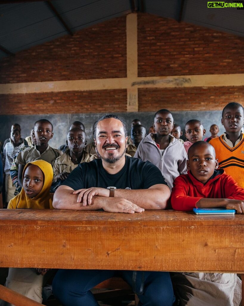 Adam Liaw Instagram - As one of the most densely populated countries in the world, and which is largely covered by mountains, and relying largely on subsistence farming, agricultural land in Burundi is scarce. This vertical vegetable garden is part of @UNICEFAustralia’s Createable project. It’s an absolutely incredible project that has exceed all of our expectations. Createable teaches schoolchildren practical skills like vertical multi-season farming, and how to build and operate highly efficient rocket stoves. The students here at Lycée Muruta in Burundi’s Muyinga Province learn about these projects, as well as things like fertiliser production and solar distillation. One thing that is clearly apparent to me on the ground here in Burundi is how systemic poverty is a multidimensional problem, and how the solutions we introduce to tackle multidimensional problems must be multidimensional themselves. Createable is a fabulous example of that. It’s not just about growing vegetables or reducing the need for firewood - it increases access to food, increases yields, decreases malnutrition, reduces the need to rent land, reduces household costs, generates income (through the sale of surplus vegetables), and keeps children in school longer by teaching practical rather than purely theoretical skills.