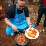 Adam Liaw Instagram - The most rewarding cooking demonstration I’ve ever done. Assisting UNICEF’s Mamans Lumière (Light Mothers) program in Ngozi Province. The Mamans Lumière program is where model mothers like Sibomana Christine teach young women about practical nutrition for their children. Ngozi has one of the highest rates of childhood malnutrition in the world, with latest reports suggesting more than 60% of children experience stunting as a result of severe malnutrition. The Light Mothers teach about the balance and sources of macronutrients in ingredients that local women may be able to access, and UNICEF supplements this with a flavourless micronutrient powder containing essential vitamins and minerals for child development. We made melangé, a nutritious Burundian stew made from whatever ingredients are on hand - in this case beans, lengalenga (amaranth, a Burundian staple), vegetables and small dried fish from Burundi’s Lake Tanganyika. The women said I was a good cook, but also commented that they had never seen a man cook before! Ngozi, Burundi