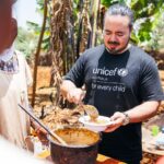 Adam Liaw Instagram - The most rewarding cooking demonstration I’ve ever done. Assisting UNICEF’s Mamans Lumière (Light Mothers) program in Ngozi Province. The Mamans Lumière program is where model mothers like Sibomana Christine teach young women about practical nutrition for their children. Ngozi has one of the highest rates of childhood malnutrition in the world, with latest reports suggesting more than 60% of children experience stunting as a result of severe malnutrition. The Light Mothers teach about the balance and sources of macronutrients in ingredients that local women may be able to access, and UNICEF supplements this with a flavourless micronutrient powder containing essential vitamins and minerals for child development. We made melangé, a nutritious Burundian stew made from whatever ingredients are on hand - in this case beans, lengalenga (amaranth, a Burundian staple), vegetables and small dried fish from Burundi’s Lake Tanganyika. The women said I was a good cook, but also commented that they had never seen a man cook before! Ngozi, Burundi