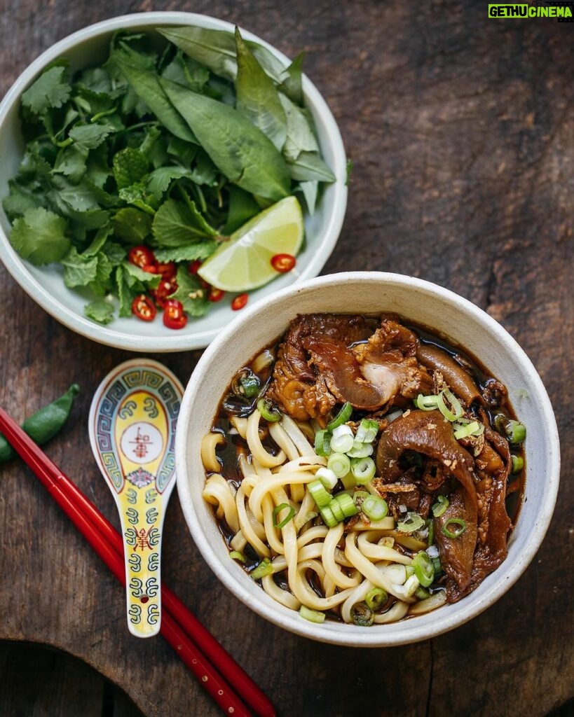 Adam Liaw Instagram - Tonight’s dinner. Braised wagyu tendon udon with Vietnamese herbs. I know you won’t believe me but this probably took 10 minutes of active time to make. Beef tendon braised in the braising liquid I used for soy sauce chicken and had in the freezer (see my post from about 2 months ago or on my website) with extra anise, tangerine peel, and black cardamom. Then the liquid diluted and seasoned to make a broth. The tendon braised using an off-heat method - bringing it to the boil the turning it off and letting it sit. I did the 4 times over the course of the day and it meant I never had to watch the pot. Just boil, switch off the heat and walk away. Perfect for when you’re in and out of the house all day like I was. Frozen udon (it’s the best udon you can get for home cooking), then served with lime, chilli and herbs.