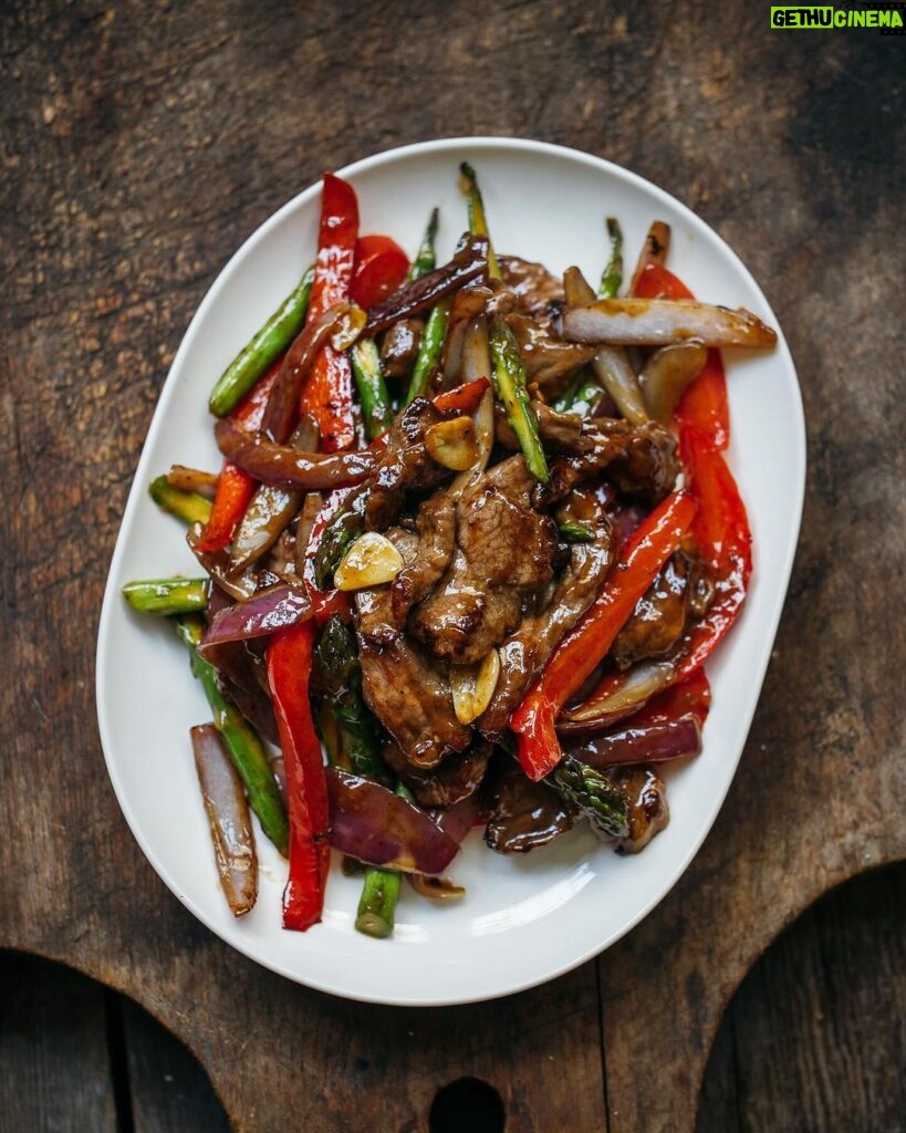 Adam Liaw Instagram - Tonight’s dinner. Beef, asparagus and capsicum with oyster sauce. Stir-frying is all about technique, but that's not to say that it's difficult. I've changed the way I stir-fry over the years to make things more efficient for home cooking. While restaurant cooking usually fries or oil-blanches the meat first, for home cooking I think it's better to cook the vegetables first and then remove them from the wok to fry the meat second, returning the vegetables to the meat later. This avoids the need to wash the wok if any meat sticks to the metal (which it usually shouldn't). This recipe fries the asparagus, capsicum and onion first, then the beef second, tossing everything together with simple seasonings of oyster sauce, soy sauce, wine and sugar. Recipe link in my profile.
