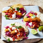 Adam Liaw Instagram - Fish finger tacos in the Taco Tuesday chapter of “7 Days of Dinner”. The fish fingers are frozen but the salsa roja is homemade and surprisingly simple - just grill some tomatoes and blend with the other ingredients.
