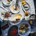 Adam Liaw Instagram - Spanish yum cha? Visiting my brother who lives in a village just outside Malaga. Seaside restaurants right on the beach serving seafood grilled over hot coals. Waiter walk around with the plates and you just grab what passes you by. The bill is tallied up at the end and written straight on the paper lining the table. With a few glasses of tinto de verano it’s the best way to spend a warm afternoon. El Tintero, El Palo