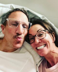 Andrea McLean Instagram - Sooo… I have just seen that Mr F put out a beautiful reel, with lovely photos and a tune that has made me cry, to celebrate the fact that 10 years ago tonight we met on a blind date that would change our lives forever. 6 years ago tonight we got married. And tonight we celebrated by making fajitas with the kids and watching I’m A Celebrity. This is us now, 11pm, glasses on, reading in bed, me with my retainer in. I’m putting this picture out because for all lovely photos and dressing up, this is where our marriage and our relationship happens- at home, doing normal stuff, and dealing with all the ups, downs, ins and outs that come with being a blended family. And I am so happy with that. I love, and am loved in return. That’s the greatest gift I could ask for. Happy anniversary Mr F. I love you. ❤️