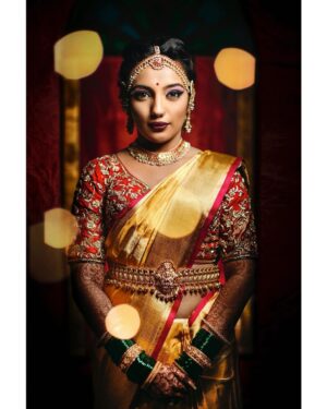 Arjun Kamath Instagram - It was an honour to capture @lakshmiambarish, an otherwise vivacious bride, in a simple moment of poise right before her wedding ceremony. She had adorned a glowing @gaurangofficial saree and was just stepping out, anticipating her big day, when I made this picture. In the photographs I share from later that day, you will see her fun-loving and bubbly self too, who can effortlessly bring the whole room to life with her mere presence. But today, I am in complete admiration of her soft smile and uncomplicated grace, making one wonder what emotions are springing inside of her.
 
Outfit- @gaurangofficial @bridesofsabyasachi 
Jewelry- @kishandasjewellery @shriparamanijewels 
Makeup- @vikrammittal5 
Hair- @awon.wungkhai 
Location- @thetamarindtreeblr 

#CapturedOnCanon with a Canon EOD 5D Mark IV & a Canon 50mm f 1.2

Lit with two @profotoglobal B10’s 
@srishtidigilife @canonindia_official 

#arjunkamathphotography #bride #portait #wedding #weddingphotography #photography #eosmaestro #mentorsinfocus #bridesofindia #weddingsutra #wedmegood #photobugcommunity #photobug
