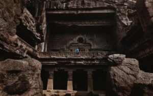 Arjun Kamath Instagram - I was recently in Aurangabad with mum and dad, where we made the unmissable trip to the marvellous caves of Ellora. A cluster of 34 caves dedicated to several religions and showcasing different architectural styles, the place was an enigma that unfurled slowly. This particular picture is of Cave 10, a majestic Buddhist monastery cum cathedral that left me awestruck in a single gaze.

It was a sunny afternoon and I was walking around in admiration of the archaic beauty all around me, when I came across this stunning facade. Instantly, I froze at the splendour of it all, and it didn’t take me two seconds to find the perfect frame that I wanted to shoot. Knowing that my parents had already ventured inside the cave, I decided to sit down on the damp ground without any care in the world. I was curiously waiting for them to wander into the balcony at some point, all set to freeze the moment. 

As soon as my father stepped in, I waited for the tourists to move away and requested him to walk to the edge of the balcony. Watching him stand there wearing a contrasting blue against the rustic brown cave, I felt like a child who had been surprised with candy and thus couldn’t hold his excitement. Dad lingered there for a while and then carried on since it was sweltering hot. But it was time enough for me to get the shot, almost as if my muscle memory had taken over, scouting the perfect composition and then clicking the shutter button on my camera. 

And although I rarely share wide shots of my travel stories, my eyes are accustomed to see the world in terms of stories and enticing frames. So, whenever I see one, I can’t help but take a photograph. This time around, the moment was all the more special, since I had the pleasure of having someone from my family grace the frame, adding a personal connection to it. 

#CapturedOnCanon with a Canon EOS 5D Mark IV & a Canon EF 24-70mm F/2.8 II USM Standard Zoom Lens

#arjunkamathphotography #dad #elloracaves #india #DoGreatWithCanon #MentorsInFocus #EOSMaestro