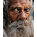 Arjun Kamath Instagram - “In his face there came to be a brooding peace that is seen most often in the faces of the very sorrowful or the very wise. But still he wandered through the streets of the town, always silent and alone.” ~ Carson McCullers #CapturedOnCanon with a @canonindia_official EOS R5 with a Canon RF 24-70mm F2.8 L Lens #arjunkamathphotography #sunrise #people #oldman #faces #eyes #man #wrinkles #wisdom #varanasi #portrait #portraitphotography #facesofindia #people #banaras #coloursofindia #india #DoGreatWithCanon #MentorsInFocus #EOSMaestro #instagood #instagram Varanasi, India