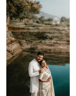 Arjun Kamath Instagram - In the tender blush of dawn, 
Love unfurls its sacred spawn. 
Sudha's saree, off-white dreams, 
Flowing by the temple streams.

Ranjith, in kurta, pure and bright, 
Together they're a classic sight. 
Beneath the boughs of Bengaluru's charm, 
Their clasped hands bring silent calm.

Laughter echoes 'midst the stones, 
Ancient whispers, future tones. 
This morn of gold, this joy, this peak, 
Where hearts converse, no need to speak.

Ethereal light, a love so bold, 
Their story in the sunlight told. 
In every frame, their spirits dance, 
Pre-wedding joys, sweet, silent romance.

Sudha + Ranjith, Bengaluru 2023

Make-up & hair - @makeoversbypriyankark @makeupbysharanya 

#CapturedOnCanon with a @canonindia_official EOS R5 

#arjunkamathphotography #photography  #weddingphotography #preweddingshoot #preweddingphotography #prewedding #bengaluru #temple #sunrise #saree #vibewithcanon #DoGreatWithCanon #canwithcanon #MentorsInFocus #EOSMaestro #instagood #instamood #instagram