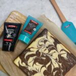 Chrissie Swan Instagram - Queen Task: Make Cheesecake Bars! These were so impressive in the end and I felt very up myself because of the way they look all swirly and marbley 😜 This Queen Natural Dark Choc Flavouring Paste is so chocolatey and so much easier to use than melting chocolate over a saucepan of water etc. Highly recommend a quick squeeze instead. Here’s the recipe folks! Side note: kids love the chopstick artistic part! 👩‍🎨 Cheesecake bars WHAT YOU’LL NEED: · 1 pack of digestives (I love McVitties!) · 80g butter, melted · 450g cream cheese, room temp · 115g caster sugar · 1 large egg · 2 tbsp flour · 1 tbsp of Queen Organic Vanilla Bean Paste · 1 tbsp of Queen Natural Dark Choc Flavouring Paste WHAT TO DO: 1. Preheat oven to 180ºC and grease up a 20x20cm pan. 2. Crush biscuits & add butter & mix until combined. 4. Press mixture into the bottom of pan and bake for 10 mins. 6. Beat cream cheese & sugar until well combined. 8. Beat in egg and Queen Organic Vanilla Bean Paste then the flour until well combined. 10. Divide the batter evenly into two bowls, flavouring one Queen Natural Choc Dark Flavouring Paste. 11. Dollop spoonfuls of the mixture over the base alternating between the flavours. 12. Using a chopstick, swirl through batter to create a marble effect. 13. Bake for 30-35 minutes, until cheesecake is set. 14. Remove from oven and cool completely on the counter. 15. Refrigerate until chilled. 16. Cut into squares and serve. 17. SCOFF! #ad @queenfinefoods #queenbaking #alittlequeendoeswonders