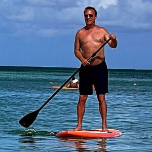 Craig Shoemaker Instagram - This might look so much cooler, making you think I’m X-Game Gary, taking on waves in the deep sea, if there wasn’t some sun-visored floating tourist on retirement vacation in the shot! 

On my way to Florida, off the standup board and back where I belong, on a standup stage. 

@visanidinnertheater Thurs-Sat.  Don’t worry.  I’ll wear a shirt. 

#aruba #keynotespeaker #tedxspeaker #coach #letmecoachyou #winningwithhumor #lovelifeagain #funnyismoney