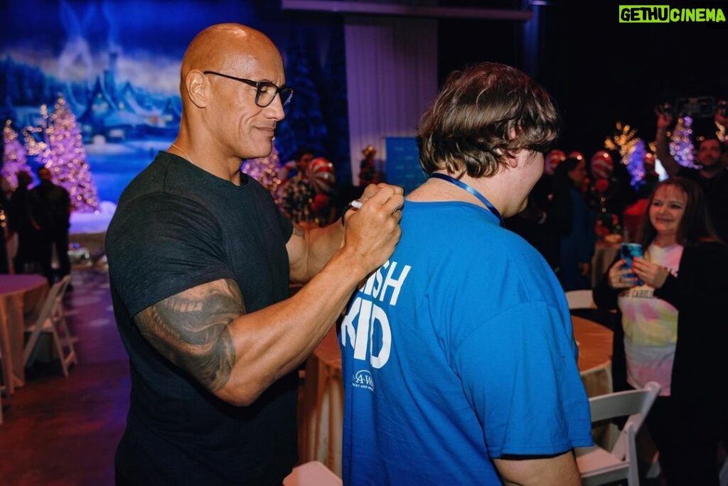 Dwayne Johnson Instagram - Droppin that old school Rock theme music for my boy Jayden Harden from @makeawishamerica! Jayden is 15 and he’s awesome!! Jayden’s wish was to meet, “the people’s champ”. He is a HUUUUUGE ROCK & pro wrestling fan and we had a BLAST chopping up his favorite wrestlers and matches!! I LOVE pro wrestling so my time with Jayden was super dope! 💪🏾🩵 I told him a little secret 🤫 that may or may not involve some dude returning to WWE to lay the SmackDown on all their candy asses 😉👋🏾 There’s a lot of negative and toxic noise out there in the world - but there’s a lot of positive, good things too, and Jayden is one of them. #MakeAWishDay #21Kids #BestDayEver