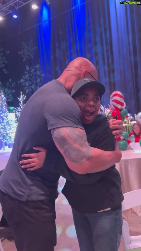 Dwayne Johnson Instagram - Wanted to a share a special moment with you guys, from my big @MakeAWishAmerica day - where I had the honor and privilege of granting the most wishes in one day (hollywood) and one of the biggest Make A Wish Days ever. I loved spending time and getting to know each and every special kid in this room — and needless to say by the time I got to my buddy Trenton here…. he literally had to walk away and duck behind a corner to let his emotions out 🥰 as his sister is crying happy tears 🥹 Happy tears are good - I’ll take ‘em all. I have so much to share with you guys of all the joy, love and positivity (and happy tears) from this day. More to come. For me, stuff like this will always be the best part of fame ❤️☝🏾 #makeawishday #bestdayever #dwanta🎅🏾