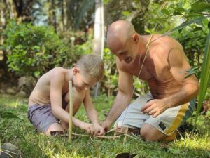 Ed Stafford Instagram - It’s good to be home 🥰. Don’t get me wrong I love my job - but nothing in the world compares to this. Ran has watched every episode of the original Marooned series since I’ve been in Africa and is now addicted to making cordage and setting traps 🪤. Don’t worry Costa Rica - no animals we harmed in the making of this post! 🤣 #traps #snares #survival #daddytime
