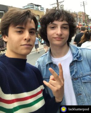 Finn Wolfhard Instagram - New Meet on the STREET LEGAL podcast with @tryingosling complete with his graphic but accurate rendition of the @lacklusterpod backstory and my sudden realization that @headgum may be generating the space time continuum itself as Posted @withregram • @lacklusterpod from @tryingosling : A couple of years ago I was eating butternut squash soup on a patio with my brother and said “I’m telling you Bogus Journey is better- oh shit, I think that’s Finn Wolfhard.” I was right. Bogus Journey is better. Also it was Finn Wolfhard. I asked him if he liked Jake and Amir even though I knew the answer was yes and we talked for a few minutes about our favourite movies and comedians. Then he had to go to a record signing and I had to get back to my butternut squash soup so we parted ways. Cut to a year later. I’m eating lunch my first day on set of a movie and I don’t really know anyone yet. Finn sits down across from me and says “Hey man, I’m Finn. Do I know you?” “We actually met very briefly in Toront-“ “Oh shit, you’re the Jake and Amir kid!” We picked up our conversation where it left off and kind of never stopped talking. Another year-ish later we have a show together on Jake and Amir’s podcast network and it’s us still talking about our favourite movies and comedians. It’s a really surreal and lovely and bizarre full circle thing that I’m super grateful for. Two guys sitting at their desks are responsible for my entire sense of humour and half of my friendships. I’m really grateful for that too. “Oh shit, you’re the Jake and Amir kid!” I was the Jake and Amir kid. And so was Finn. We both still are. Lackluster Video 02 comes out TODAY. Special Guest: Amir Valerie Blumenfeld himself. 💙💛