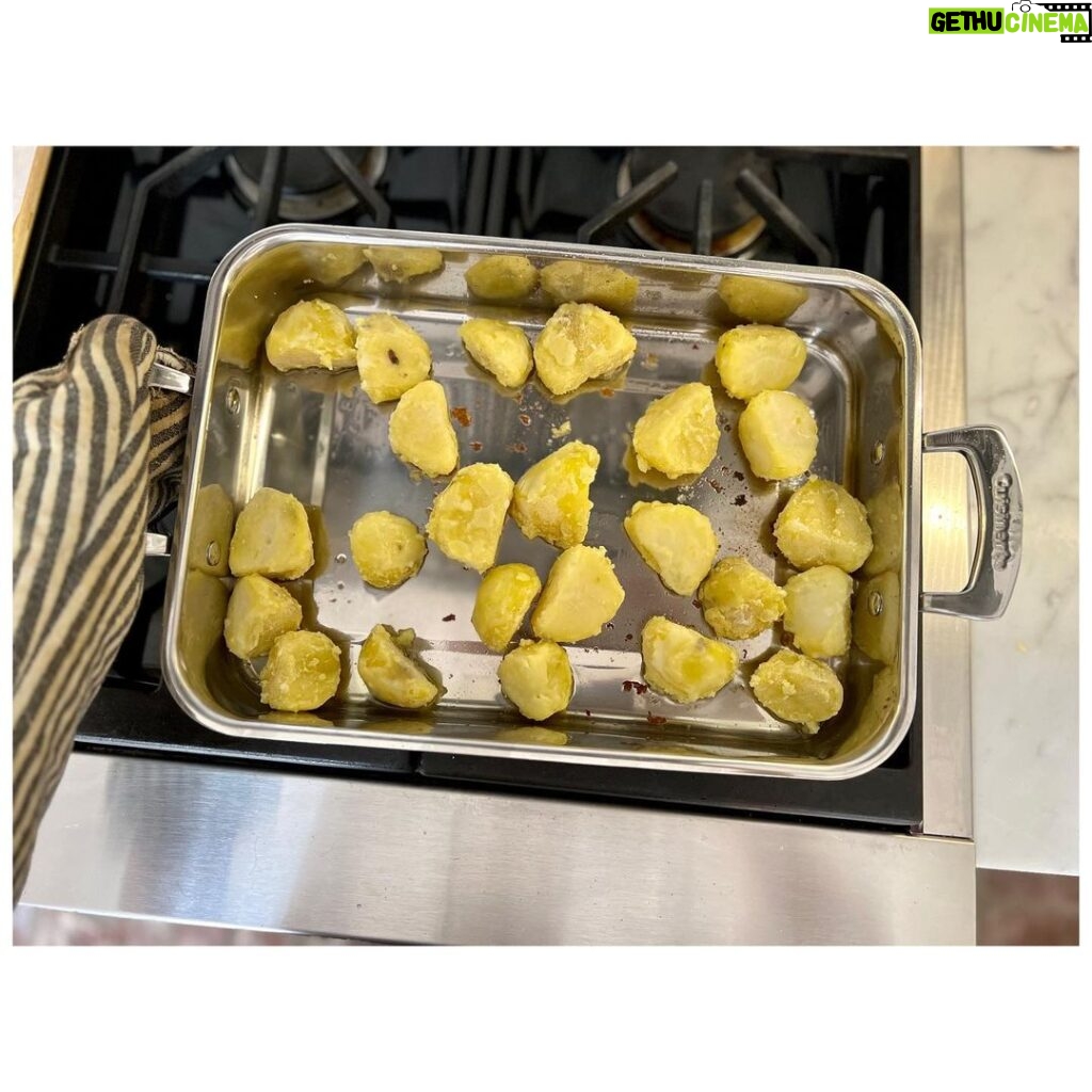 Ginnifer Goodwin Instagram - Dear @missjobaker, Here is my babbling recipe for #roastpotatoes. Slide 2. I prep my (often Yukon gold) #potatoes at least 24 hours before I want to cook them. I peel said potatoes and cut them into same-ish sized pieces. I do NOT parboil them. I generously salt the potatoes and STEAM them for as long as it takes me to drink a cup of tea, get sucked into a book, and go, “Oh no! The potatoes!” I bet this is a 15 minute experience? Then I take a skewer and rake that across a potato. Is there evidence of potato-ness on said skewer? If so, I move on to… Slide 3. Holding the lid firmly in place, I bang the potatoes about the steam basket. I then remove the lid and let the potato steam do it’s go-away thing. Slide 4. I line a baking sheet with a piece of parchment paper and spread the potatoes out so that they are not touching. I cover the whole thing in plastic wrap, because I haven’t found a better solution. I put the baking sheet in the freezer til whenever-in-the-future I need to roast potatoes. The freezer is the secret weapon. Slide 5. On another day when I’m hungry, I preheat the oven to 400F. I coat my roasting tin with a high-smoke-point oil — my fam prefers something animal-based — and I use only enough to make the whole bottom glassy and that’s IT. I stick the oily tin in the oven to warm up for 5-ish minutes. NOW I go get my potatoes out of the freezer. I put the tin on the stovetop, turn up the heat to medium (if the tin is stove-top safe) and dump the potatoes in the tin. I step back! They splatter! Can you see in the photo that I use such a small amount of oil that it’s ALMOST all soaked up by the potatoes? As quickly as possible, I flip them around with tongs in what oil is left. I pop the tin in the oven. I do not touch the potatoes again. Slide 1. I wish I could tell you how long I roast my potatoes. It could be 40 minutes? I just watch the color and I fiddle with the temperature so that they come out after everything else is ready to serve. They are effing crispy on the outside and effing fluffy on the inside. Lemme know if you give ‘em a try! P.S. I threw in a pic of my favorite platter, because… Digby.