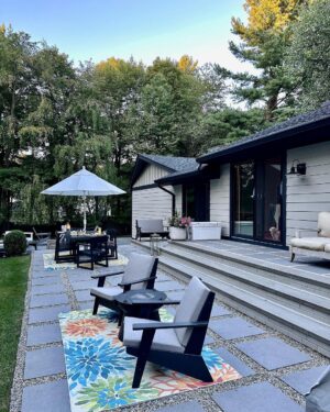 John Colaneri Instagram - A little after and before in the rear of our home. It has gone through some massive transformations over the past couple of years. I have not shared any pictures of the rear complete yet.  With the new @jameshardie siding and patio by @polycor_hardscapes it is a great place to entertain and just relax. We now have around 2,000 sq ft of patio space which makes a huge difference to the property.  With summer ending the fall is my favorite season by far and I cannot wait to sit around the fire 🔥 pit.

@woodhavenlumber @northernvalleystone 

#design #designinspiration #curbappeal #exteriordesign #exteriordecor #designgoals #njdesigner