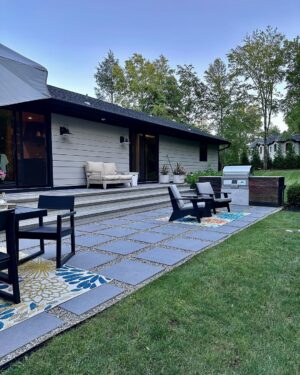 John Colaneri Instagram - A little after and before in the rear of our home. It has gone through some massive transformations over the past couple of years. I have not shared any pictures of the rear complete yet.  With the new @jameshardie siding and patio by @polycor_hardscapes it is a great place to entertain and just relax. We now have around 2,000 sq ft of patio space which makes a huge difference to the property.  With summer ending the fall is my favorite season by far and I cannot wait to sit around the fire 🔥 pit.

@woodhavenlumber @northernvalleystone 

#design #designinspiration #curbappeal #exteriordesign #exteriordecor #designgoals #njdesigner