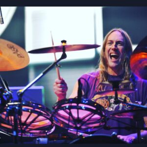 John Dolmayan Instagram - Even before I joined the band we would sit around and marvel at the uniquely intricate drumming of Danny Carey . Tool to me is like a mix of Pink Floyd and Rush, modernizing those sounds and adding an even more prolific singer . I spent many nights in the crowd during Ozzfest laying on the grass and enjoying the power and beauty amplified by the massive speakers . (Their Led Zeppelin cover is amazing !)At some point someone had the bright idea of challenging them to a basketball game ( we lost ). This was the second time system lost ( first time was to slayer , they killed us ) but we began a friendship between the bands that is still thriving today. Danny is on the Mount Rushmore of modern drummers , he balances technic and style perfectly . For someone as tall as he is he’s incredibly graceful and there is a marvelous liquidity to his drumming style . Danny is a shy , introspective person but once you get him comfortable his inner joy and zest for life overtakes you. I have been fortunate to have played with them on stage going back and forth on timbales as he played a solo. Every time we did this was such a thrill and again I count my blessings that these opportunities have been afforded to me. I can’t explain how much respect and admiration I have for Danny and Tool in general . I pray we do a tour together one day and create a massive 2 or 3 drummer solo . I promise to give you a run for your money Danny 🤙