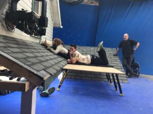 Kiera Allen Instagram - Definitely my favorite behind-the-scenes photo of the roof-crawling. Maybe my favorite photo ever. Starring our amazing 1st assistant director on Run, Reed Makayev.

P.S. The man lying Wicked-Witch-of-the-East-style under the house is NOT dead, just holding onto the stunt wires.