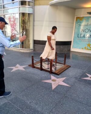 Kristen Schaal Instagram - Today I donated the first ever @hwdwalkoffame Foot Bridge at Andy Kaufman’s ceremony. My hope is that no one’s dirty feet, dog shit, bird shit, or gum will ever touch his precious star that took 40 years after his death to get. I also donated a rug to go over the bridge to keep it clean too. Thank you to Arturo Guzman and his friend for building it, Rich Blomquist for the rug idea (zoom in on rug), the Kaufman’s for letting me be a part of this historical event, and to Andy for the inspiration.