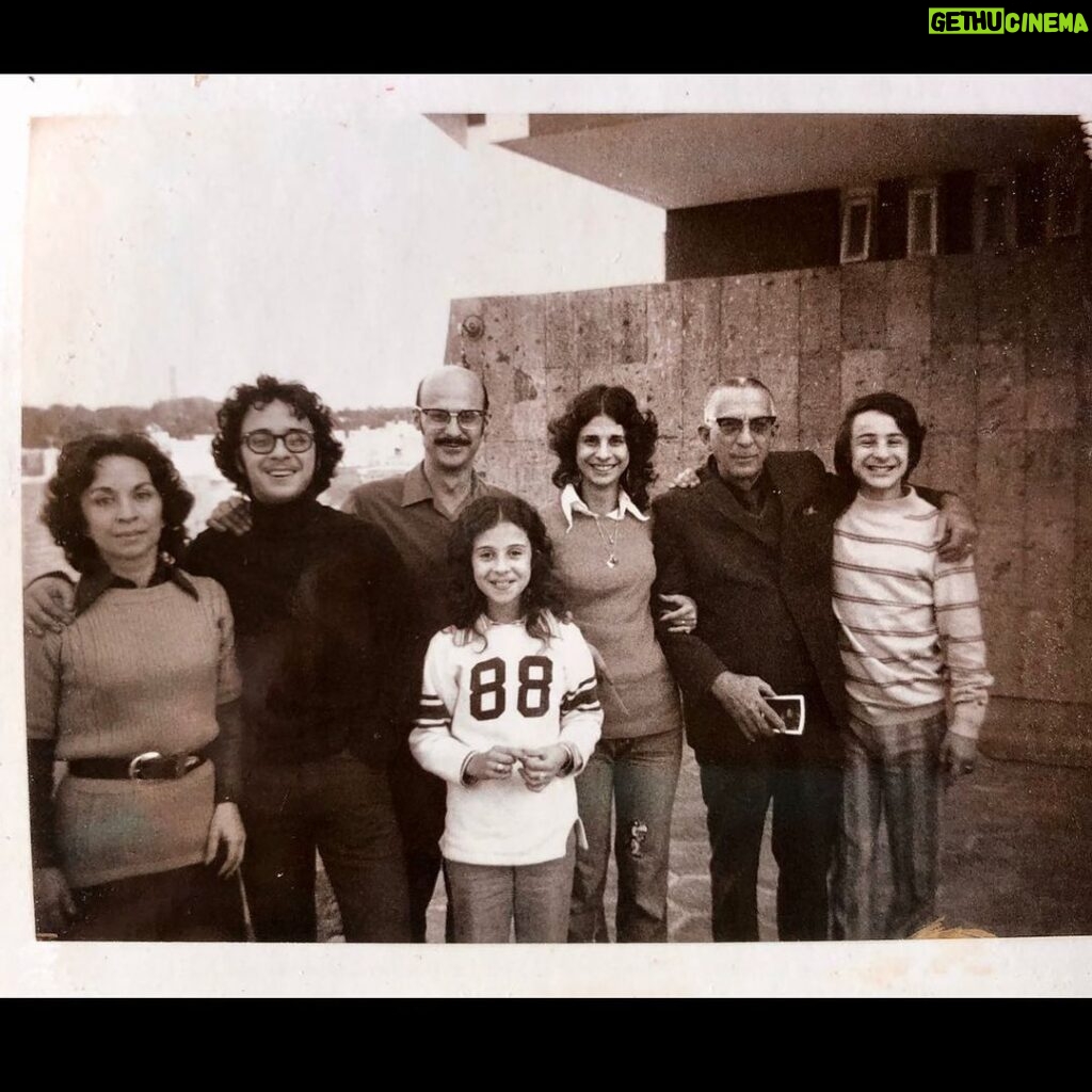 Maria Hinojosa Instagram - This foto right here is my life. Mi vida. Tampico. 1970s. Mi abuelito. My gorgeous parents. My fly sister. My cool bros. And me. I think I was trying to fit in with American kids by trying to like sports. I think this is a hockey jersey. Well, because I lived in Chicago then. Hockey, of course. My cousins from Mexico sent this last night in our chat abt our Tampico memories when about 20 of us would gather for summer or Christmas celebrations and I just wanted to share. This is the real me. 🇲🇽