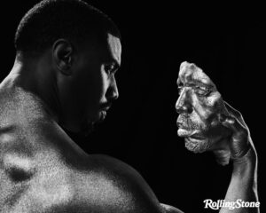 Michael B. Jordan Instagram - Creating a chapter in Adonis’  journey has helped me realize the strength in myself and being a master of my own universe. Exploring all the characters narratives and how they navigate the different parts of themselves made me more aware of the different personalities that live inside my soul. Thank you to Adrienne for capturing these dimensions and thank you to Rolling Stones for allowing me to share my story. 

@Rollingstone 
Photographer @adrienneraquel x @sn37agency
Writer @carvell_wallace
Creative Director @Joe_Hutchinson
Director of Photography & Deputy Creative Director @Emma.V.Reeves 
Fashion Direction @Thealexbadia
Deputy Photo Director @slecca
Senior Visuals Editor @photoeditorjoe
Head of Video @kimberlyaleah
Video Producer @ilanawoldenberg
Video DP @helkifrantzen
Director of Social Media @waiss_aramesh
Market Editor @luiscampuzano
Producer@petty_cash_production
ProductionDesigner @paidfollower001
Face & Chest Sculpture and Body paint by @hollysilius for @studio.silius 
MBJ Creative Director @leovolcy
Styling @jasonbolden
Tailor @erinleighcastle
Barber @jove14
 
Grooming @tashareikobrown at @thewallgroup  Lighting Director @lens_face
Photography Assistance @lance.i
Digital Technician @stowe_richards
Set Dresser @_nicogeyer
Hair Assistant @alexhenrichs Stylist Assistance @johnmumblo