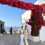 Natalie Negrotti Instagram - First time in Oia Santorini and I’m blown away by it’s beauty. My feet got so swollen I had to wear my pink shower chanclas to sight see before I bought matching Greek made sandals with my prima since my sneakers didn’t fit me! 😂 we rented a convertible red Fiat 🚗 and drove around exploring Santorini, Greece Oia, Santorini