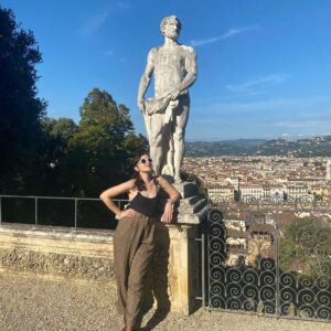 Noël Wells Instagram - ugh I went to Italy. It was so beautiful I have been in a pretty distraught since landing back in the states. There are barely any advertisements, people care about energy conservation, no one was really on their phones, everyone was chill (though on controversial note, food was just ok but to be fair I am not a food driven person.) we wandered into medieval towns I truly had no idea could possibly exist, I fucking drove a boat of a car in these medieval towns I deserve an award. I felt pretty humbled in the face of what humans have been compelled to create (mostly for god, ain't so bad to believe!). I stood at the top of a tower da Vinci drew from and what else? All the churches! I mean was I a nun in a past life?! At a certain point I realized some of the most beautiful things already exist so I could take a lot of pressure off myself and just be dumb and happy to witness life, though of course I do want to make some pretty things of my own. Also do I make a zine of this trip would you want it I have hundreds of photos! All pics of me by Gabi!