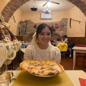 Noël Wells Instagram - ugh I went to Italy. It was so beautiful I have been in a pretty distraught since landing back in the states. There are barely any advertisements, people care about energy conservation, no one was really on their phones, everyone was chill (though on controversial note, food was just ok but to be fair I am not a food driven person.) we wandered into medieval towns I truly had no idea could possibly exist, I fucking drove a boat of a car in these medieval towns I deserve an award. I felt pretty humbled in the face of what humans have been compelled to create (mostly for god, ain't so bad to believe!). I stood at the top of a tower da Vinci drew from and what else? All the churches! I mean was I a nun in a past life?! At a certain point I realized some of the most beautiful things already exist so I could take a lot of pressure off myself and just be dumb and happy to witness life, though of course I do want to make some pretty things of my own. Also do I make a zine of this trip would you want it I have hundreds of photos! All pics of me by Gabi!