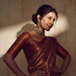 Raashi Khanna Instagram - In a world of trends, my heart belongs to sarees ♥️ #timeless Makeup @makeupbyshefali.s Hair @zoequiny.hair Jewelery @tritiyaa.jewellery 📸 @ishan.n.giri