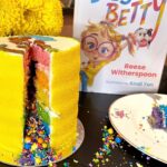 Reese Witherspoon Instagram - This Busy Betty is ready for the weekend, y’all 🫠😜 Pick up a copy wherever books are sold. Also this rainbow cake from @flourshop is 💯 🌟
