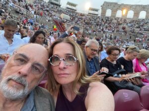 Sheila Kelley Instagram - Last summer we travelled through the magnificent country of Italy. This photo is from the outside opera house in Verona. In the middle of the opera, a torrential thunderstorm struck, and Richard and I were separated from each other for about an hour. It was chaos. People were running and screaming, in all directions, trying to get out of the rain and away from the lightning.
⠀⠀⠀⠀⠀⠀⠀⠀⠀
When we were finally able to get to each other I broke down in his arms with such relief. He is home. 
⠀⠀⠀⠀⠀⠀⠀⠀⠀
Love’s journey is an adventure, where challenges become the threads weaving a tapestry of connection. In the depth of love, we find the most rewarding chapters – building a life and a home together. 💖🏡 #LoveEndures #JourneyTogether